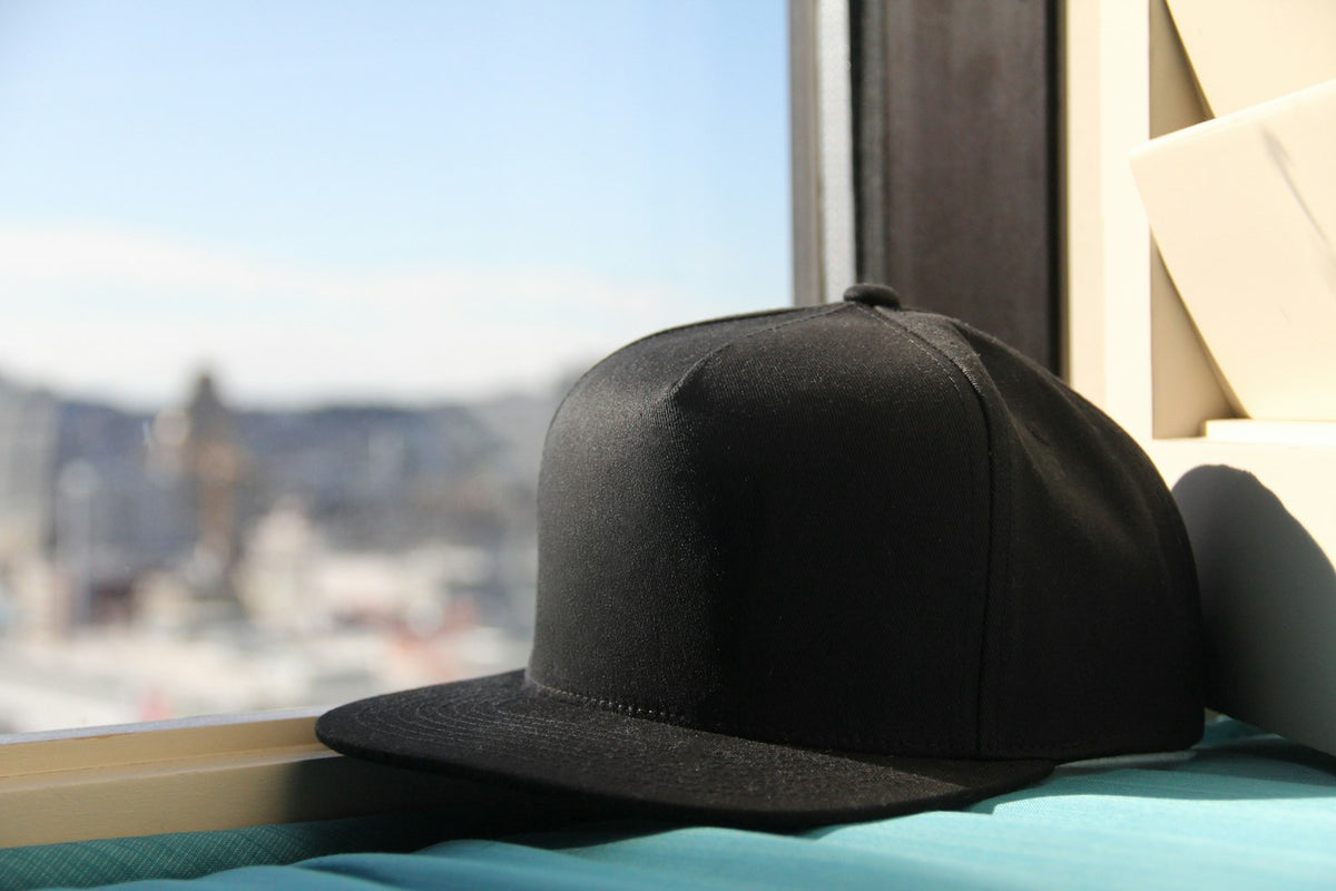 Gorra negra junto a una ventana